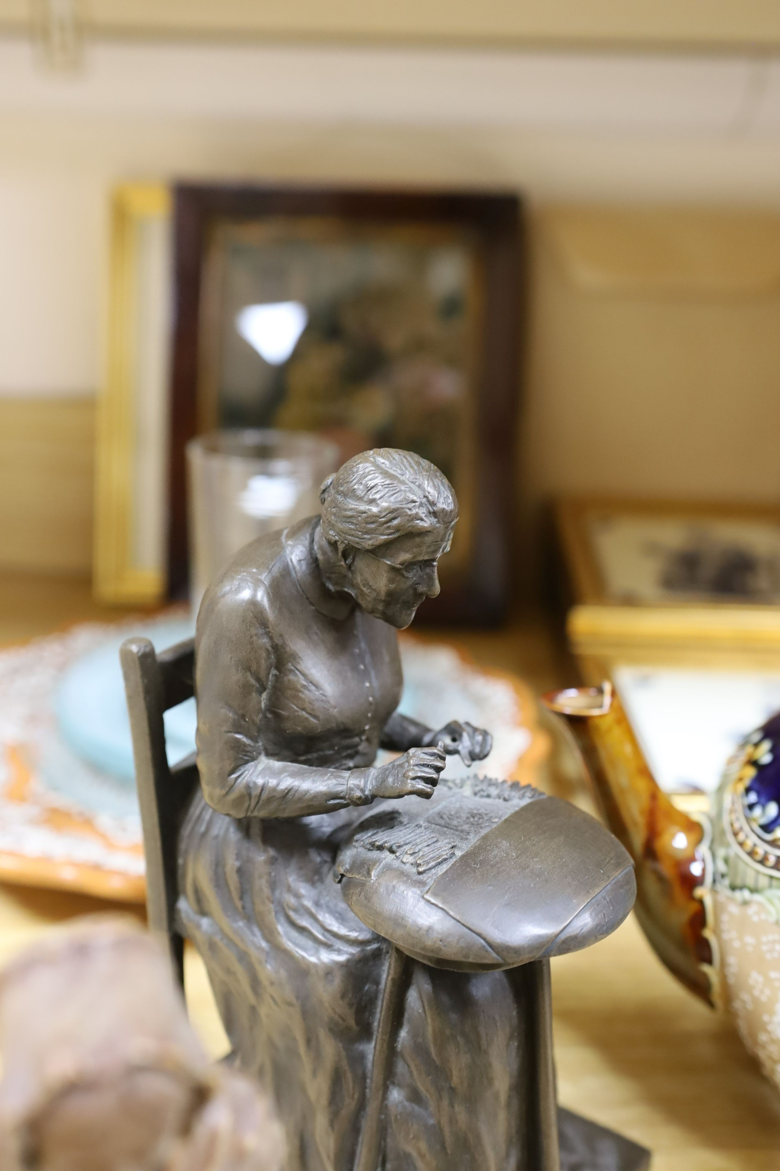 A cold cast bronze, Bobbin lace maker, similar carved wood figure, ceramic lace-pattern dish etc